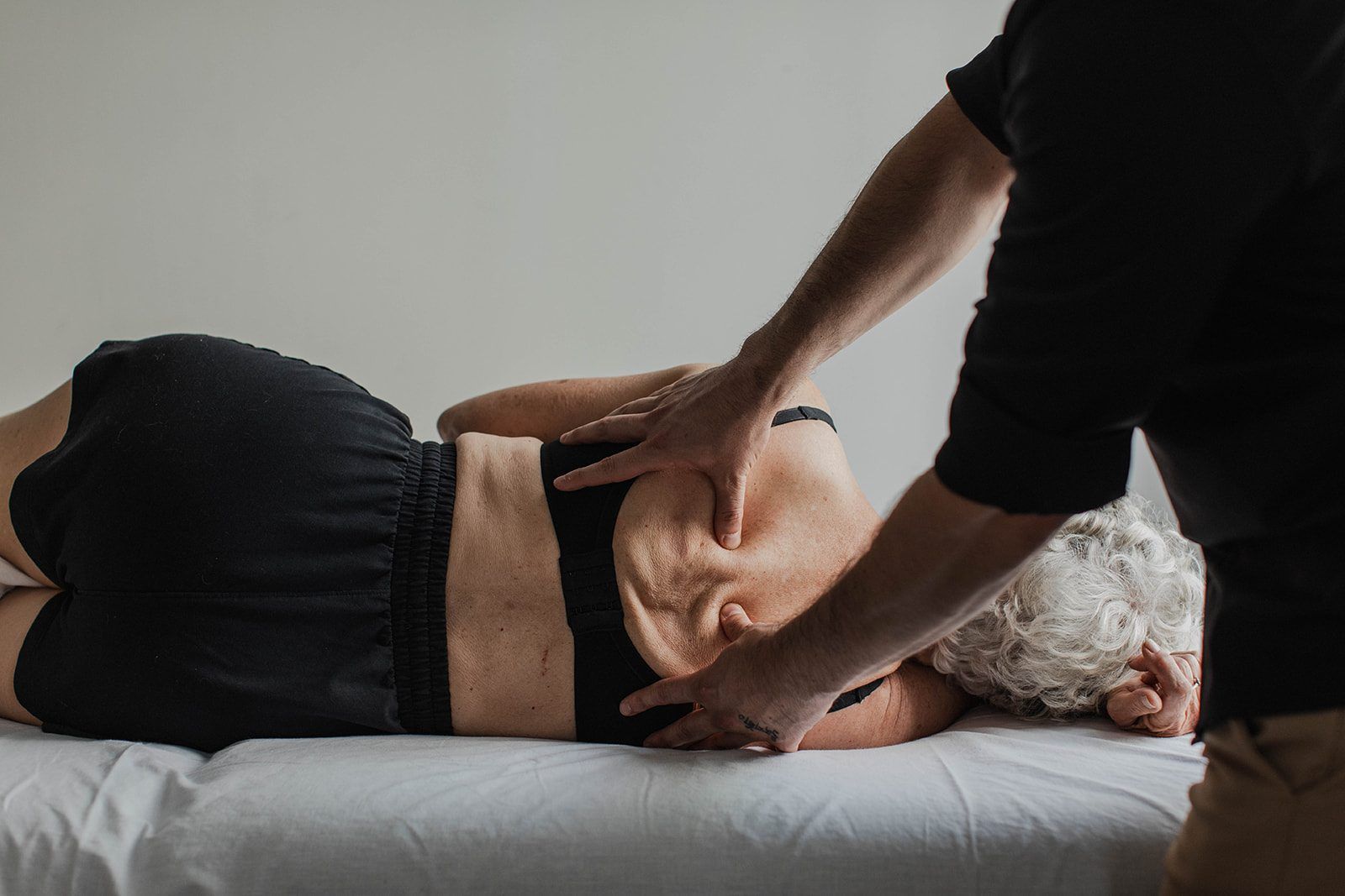 Ryan Caputi doing hands-on Rolfing work on a client's abdomen