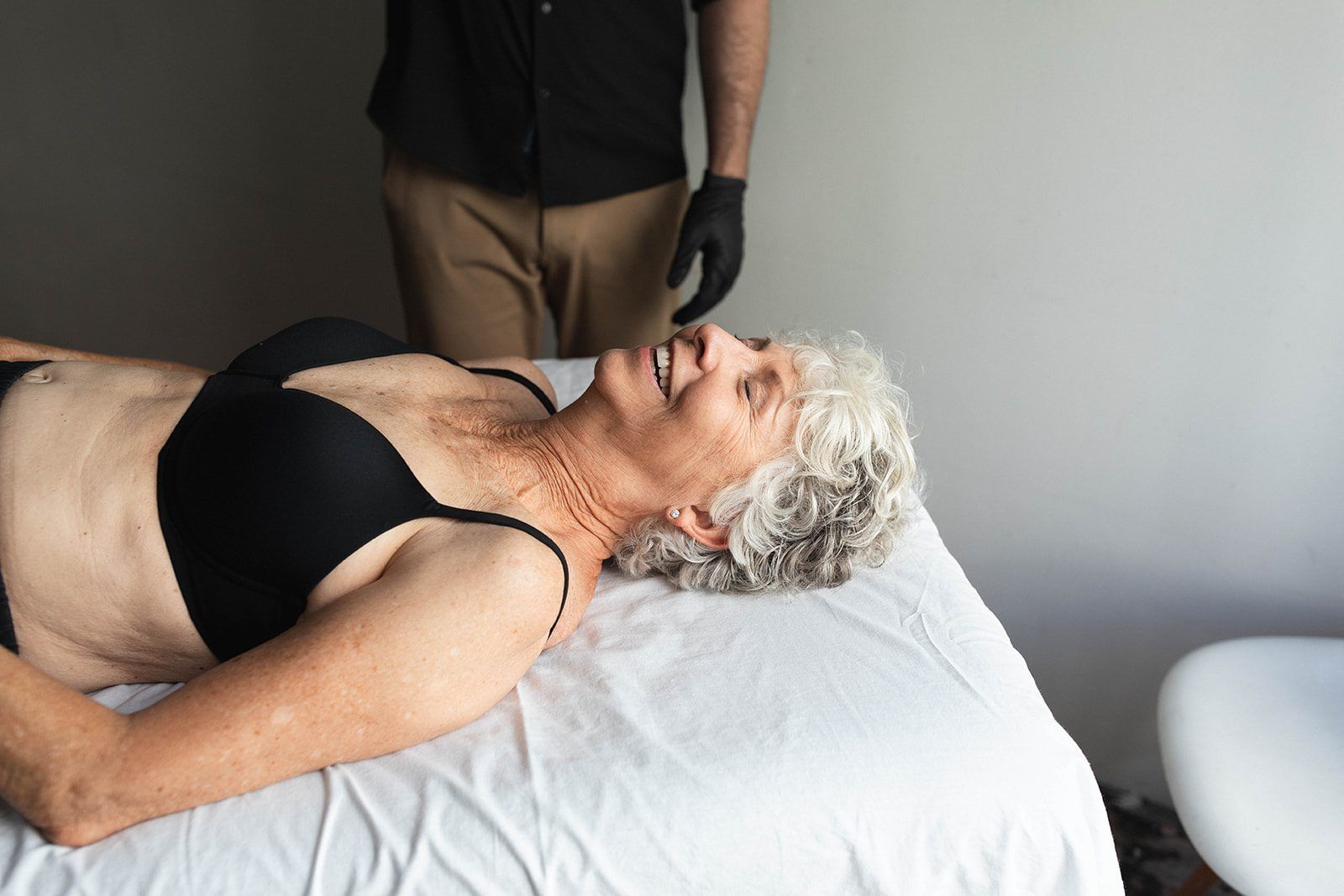 Ryan Caputi doing hands-on Rolfing work on a client's shoulder and upper back