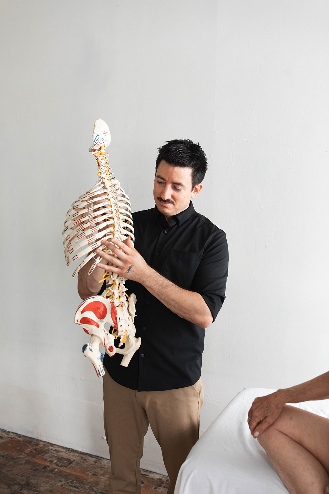 Ryan explaining anatomy with a skeleton model